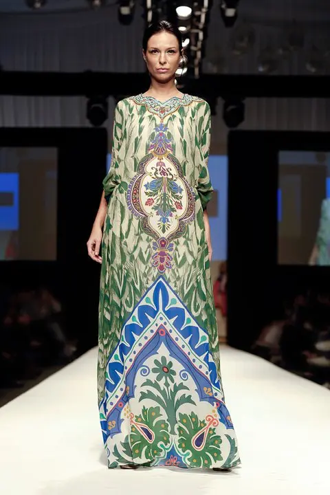 Arabian Nomads : Exclusive Arab Dress Collection at DFW, SS11 14 Crepe silk kaftan in green tones with falcon wing and Islamic floral print, gathered at the waist, floral neckline, and crystal stick-on embellishments.